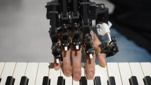 Surpassing Limits of Virtuosity of Pianists by Exoskeleton